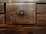a wooden dresser with a drawer on top of it