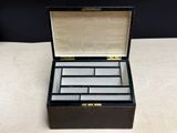 an old black and white box with four compartments on a table