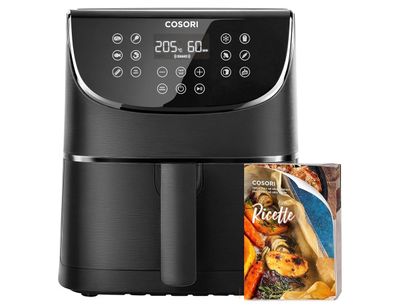 a black air fryer sitting next to a packet of food