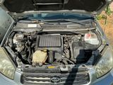 a car with its hood open and the engine in the back