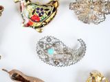 many different types of brooches on a white surface