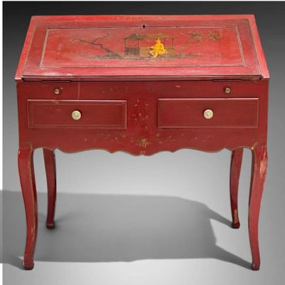 une image représentant une table rouge sur laquelle se trouve un tiroir