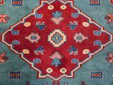 an image of a blue and red rug with a diamond design on it