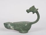 an image of a green statue of a dragon on a white background