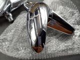 a pair of silver cufflinks sitting on top of a piece of cloth