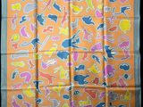 an orange scarf with colorful cats and dogs on it