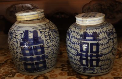 two blue and white vases sitting on a table