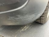 a close up of a car ' s front bumper and tire