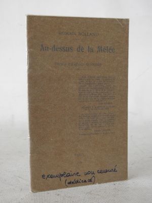 an old book sitting on top of a white table next to a white wall