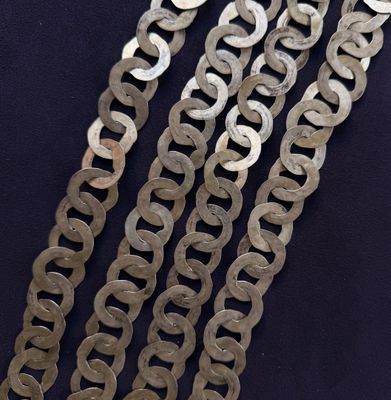 a close up of a metal chain on a black surface