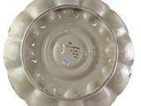 a white plate with a design on it on a white background
