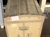 une grande caisse en bois posée par terre dans une pièce