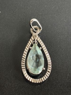 a close up of a pendant on a black surface