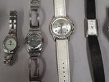 a lot of watches that are sitting on a table