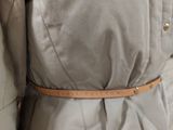 an image of a woman wearing a jacket and a belt