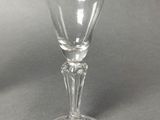 a wine glass with a tag on it on a table