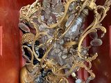 a gold statue of a shoe with a bunch of crystals in it