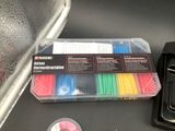 a box of assorted colored straws on a table