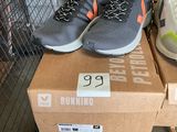 many pairs of running shoes on a box in a store