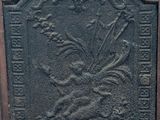 an old cast iron plaque with a bird and flowers on it