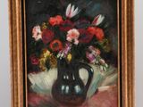 a painting of flowers in a vase on a easel