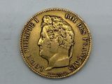 a close up of a gold coin on a white surface