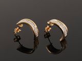 a pair of gold and diamond hoop earrings