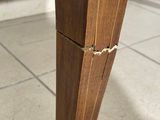 a close up of a wooden pole with a hole in it