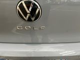 volkswagen golf badge on the back of a car in a parking lot