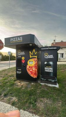 a person taking a picture of a box with a pizza on it
