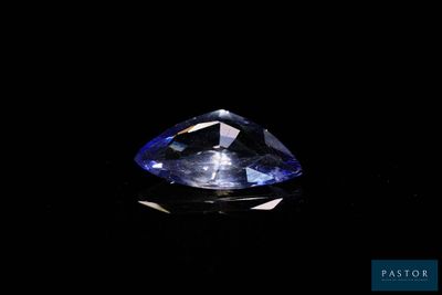 a close up of a blue diamond on a black background