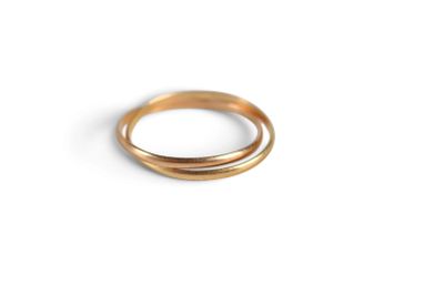 a close up of a gold ring on a white surface