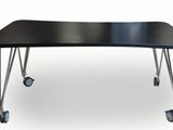the black table is on wheels and has a black top