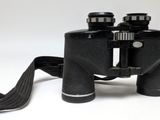 a close up of a pair of binoculars on a white surface