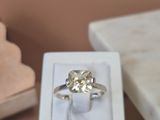 a white box with a ring inside of it on a table