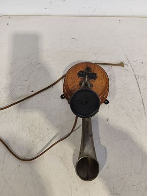 a telephone that is sitting on a white surface