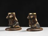 two vases with bears on them sitting on a white surface
