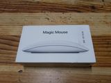 a box with a white mouse on it on a wooden table