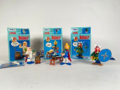 five toy figurines of different characters on a white surface