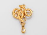 an image of a gold snake broochle on a white background