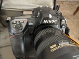 a camera with a lens attached to it sitting on a chair