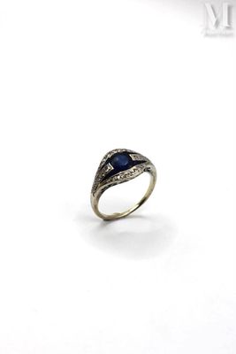 a close up of a ring with a blue stone in it