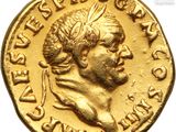 a close up of a gold coin with a head of a man