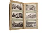 an old book opened to show pictures of a city