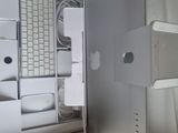 a hand that is holding a mouse in front of a computer