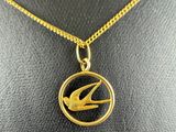 a gold necklace with a bird on it