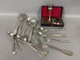 a lot of silver spoons and forks in a box