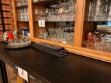 a black counter top with a bunch of glasses on it