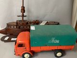 a toy truck that is sitting next to a ship