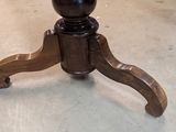 a wooden table with a black top and a brown base